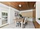 Dining room showcases a wood-planked ceiling, stylish furnishings and sun-filled windows at 3818 W San Miguel St, Tampa, FL 33629