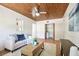 Living room with wood-plank ceiling has comfortable seating, and laundry at 3818 W San Miguel St, Tampa, FL 33629