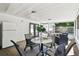 Cozy screened-in porch with dining table and chairs, offering a relaxing outdoor experience at 3818 W San Miguel St, Tampa, FL 33629