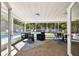 The light and airy sunroom provides access to the pool and features ample lounge seating and dining space at 3818 W San Miguel St, Tampa, FL 33629
