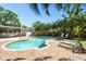 Stunning pool area surrounded by palm trees, with lounge chairs and a screened-in porch at 3818 W San Miguel St, Tampa, FL 33629