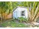 Exterior view of shed in a tropical backyard, surrounded by trees at 3818 W San Miguel St, Tampa, FL 33629