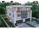 Contemporary three-story home with a modern design, dual balconies, and a two-car garage, set amongst mature trees at 4509 W North A St # 1, Tampa, FL 33609