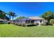 Expansive backyard showcasing a screened-in lanai, lush landscaping, and a well-maintained lawn at 4904 Breyer Wood Ct, Valrico, FL 33596