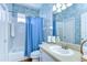 Bright bathroom featuring patterned wall paper, a tub/shower combo and plenty of natural light at 4904 Breyer Wood Ct, Valrico, FL 33596