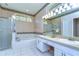Large bathroom features a walk-in shower, soaking tub, dual sinks, and decorative accents at 4904 Breyer Wood Ct, Valrico, FL 33596