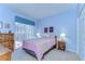 Comfortable bedroom featuring a sliding glass door, dresser, nightstands and bright natural light at 4904 Breyer Wood Ct, Valrico, FL 33596