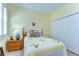 Cozy bedroom featuring a comfortable bed, wood furniture, shuttered windows and a closet for ample storage at 4904 Breyer Wood Ct, Valrico, FL 33596