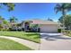 Beautiful home with a two-car garage, mature palms, and manicured lawn at 4904 Breyer Wood Ct, Valrico, FL 33596