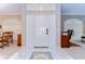 Bright foyer featuring white tile flooring, and an elegant front door with decorative side windows at 4904 Breyer Wood Ct, Valrico, FL 33596