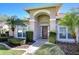 Inviting front entrance with an arched entryway and well-manicured landscaping at 4904 Breyer Wood Ct, Valrico, FL 33596