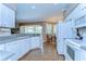Bright kitchen with white cabinets, modern appliances, and views to the lanai and dining area at 4904 Breyer Wood Ct, Valrico, FL 33596