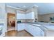 Bright kitchen features white cabinetry, gray countertops, and wood-look tile flooring at 4904 Breyer Wood Ct, Valrico, FL 33596