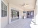 Relaxing covered patio featuring tile flooring, a ceiling fan, and ample space for outdoor seating at 4904 Breyer Wood Ct, Valrico, FL 33596
