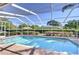Relaxing screened-in pool area features a clear blue pool and a brick paver surround for outdoor enjoyment at 4904 Breyer Wood Ct, Valrico, FL 33596