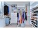 Spacious walk-in closet with custom shelving, drawers, and hanging rods for optimal organization and storage at 4904 Breyer Wood Ct, Valrico, FL 33596