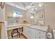 Elegant bathroom with granite countertops, decorative mirror, and a hanging light at 5603 97Th N Way, St Petersburg, FL 33708