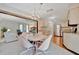 Open dining area with chandelier, connects to living room and kitchen, offering a seamless living experience at 5603 97Th N Way, St Petersburg, FL 33708