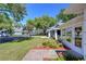 Well-maintained home with lush front lawn, beautiful flowers, and a welcoming entrance at 6644 Juniper Ct, Zephyrhills, FL 33542