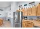 Modern kitchen with stainless steel appliances, wooden cabinets, and an adjacent dining area at 808 Centerwood Ct, Brandon, FL 33511