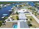 An overhead perspective of several homes near the canals, with boat docks and swimming pools at 810 Blue Heron Blvd, Ruskin, FL 33570