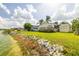Back exterior with manicured lawn and waterfront views at 8632 Fantasia Park Way, Riverview, FL 33578