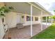 Charming covered entry porch with tiled patio, side yard and manicured lawn with direct access to the front door at 8632 Fantasia Park Way, Riverview, FL 33578