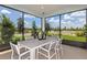 Enclosed patio with a large table and chairs offers an ideal outdoor dining experience at 9816 Crescent Moon Dr, Riverview, FL 33578