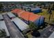 Aerial view of condo buildings with red roofs, balconies, and covered parking at 9980 Eagles Point Cir # 1, Port Richey, FL 34668