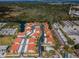 Stunning aerial view of the community showcasing the pool, landscaping, and residential buildings with red roofs at 9980 Eagles Point Cir # 1, Port Richey, FL 34668