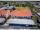 Aerial view of condo buildings with red roofs and covered parking at 9980 Eagles Point Cir # 1, Port Richey, FL 34668