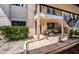 Ground floor condo entrance with patio, stone details, and ample landscaping at 9980 Eagles Point Cir # 1, Port Richey, FL 34668