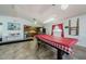 Bright game room with pool table and adjacent kitchen at 9980 Eagles Point Cir # 1, Port Richey, FL 34668
