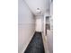 Entryway with a dark rug, tiled floors, and unfinished drywall; perfect for renovation enthusiasts at 9980 Eagles Point Cir # 1, Port Richey, FL 34668