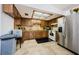 Kitchen with wooden cabinets, tile backsplash, and stainless steel appliances at 9980 Eagles Point Cir # 1, Port Richey, FL 34668