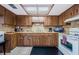 A fully equipped kitchen features wooden cabinets, tile floors and stainless steel refrigerator at 9980 Eagles Point Cir # 1, Port Richey, FL 34668
