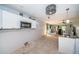 Open kitchen and living area with tiled floor, decorative fan, and abundant natural light at 9980 Eagles Point Cir # 1, Port Richey, FL 34668