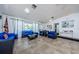 Inviting common area with tile floor, wicker seating and large windows at 9980 Eagles Point Cir # 1, Port Richey, FL 34668
