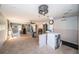 Bright, large living area with tiled floors, ceiling fan, and connection to kitchen space at 9980 Eagles Point Cir # 1, Port Richey, FL 34668