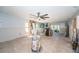 Large open-concept space with tile floors, fireplace, and abundant natural light for flexible living at 9980 Eagles Point Cir # 1, Port Richey, FL 34668