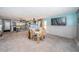 Renovation-ready living room with tiled floors, a view of the kitchen, and abundant natural light at 9980 Eagles Point Cir # 1, Port Richey, FL 34668