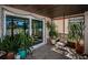 Enclosed tile patio with sliding glass doors, decor, and lots of plants at 9980 Eagles Point Cir # 1, Port Richey, FL 34668