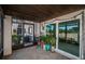 Enclosed tile patio with sliding glass doors, lighting, decor, and plants at 9980 Eagles Point Cir # 1, Port Richey, FL 34668