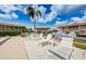 Community pool deck featuring comfortable lounge chairs, a BBQ grill, and well-maintained landscaping at 9980 Eagles Point Cir # 1, Port Richey, FL 34668