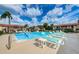 Resort-style pool with sun loungers and a lush green landscape at 9980 Eagles Point Cir # 1, Port Richey, FL 34668