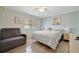 Cozy bedroom with soft lighting, a comfortable bed, and a relaxing seating area at 110 E Saint Lucia Loop, Apollo Beach, FL 33572