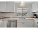 An efficient kitchen design with stainless steel appliances and ample countertop space at 110 E Saint Lucia Loop, Apollo Beach, FL 33572