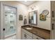 Bathroom featuring granite counters, modern light fixtures, and a large glass shower at 1108 Cordova Grn, Seminole, FL 33777