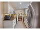 Well-lit kitchen featuring stainless steel appliances, granite countertops, and ample white cabinetry at 1108 Cordova Grn, Seminole, FL 33777