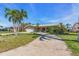 Well-manicured front yard featuring an inviting facade with arched entryway and a two-car garage at 11674 Grove St, Seminole, FL 33772